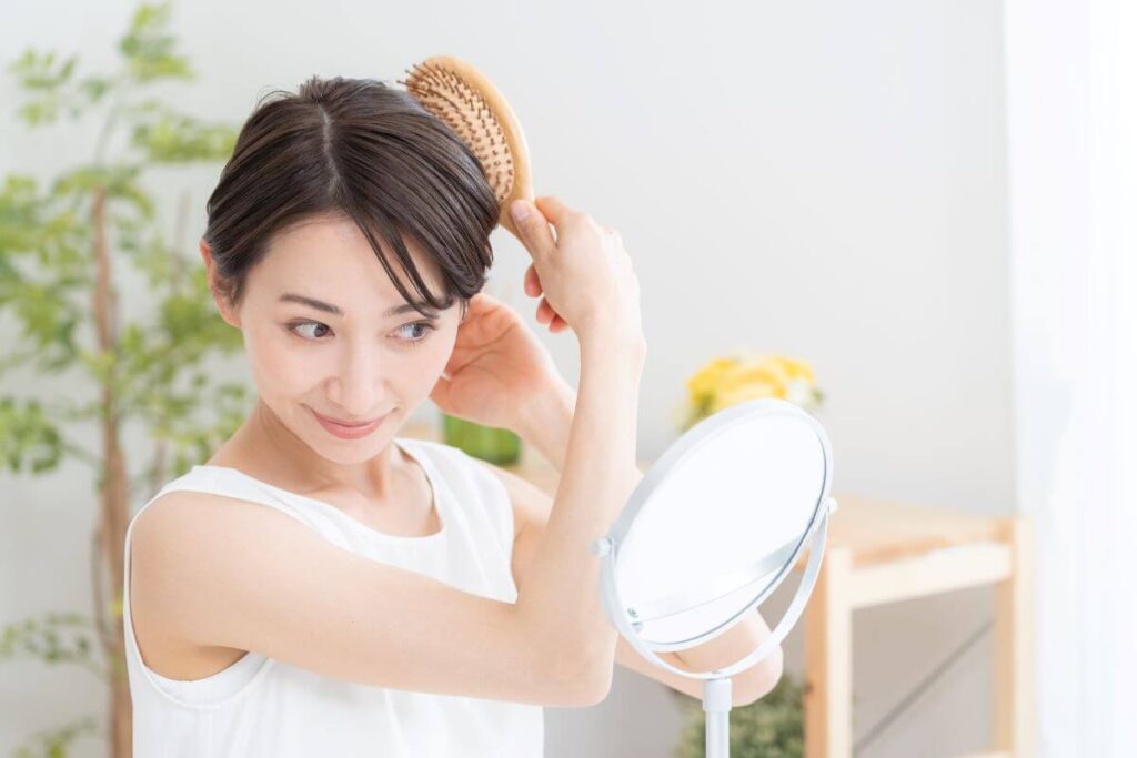 woman combing her hair